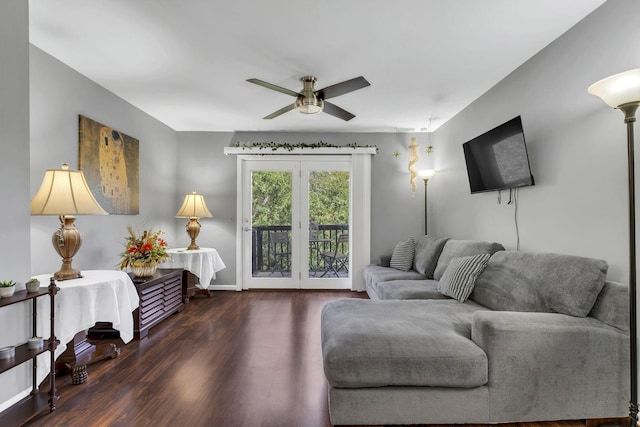 living room featuring dark hardwood / wood-style flooring and ceiling fan