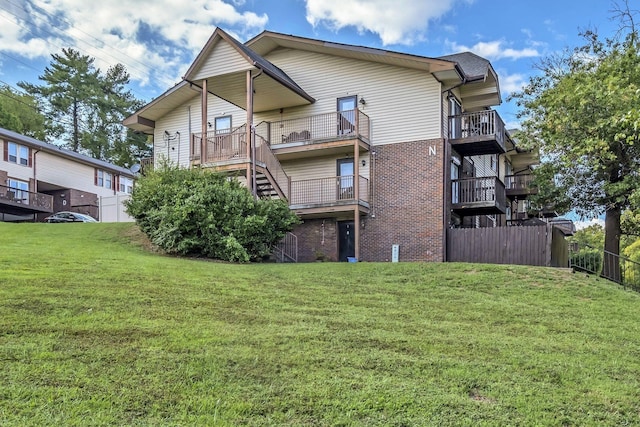 rear view of property with a lawn