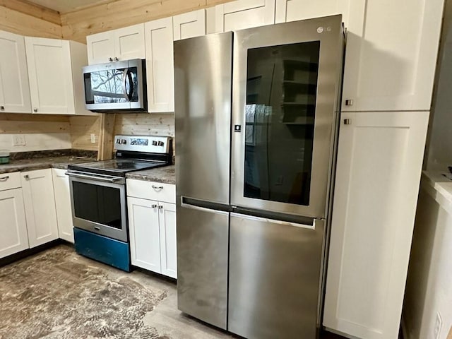 kitchen with stainless steel appliances and white cabinetry