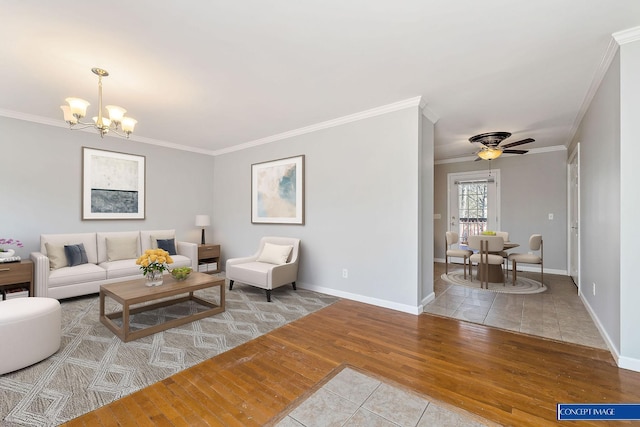 living room with ornamental molding, ceiling fan with notable chandelier, and light tile patterned floors