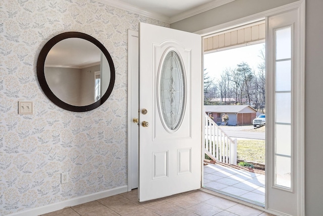 foyer with ornamental molding and light tile patterned floors