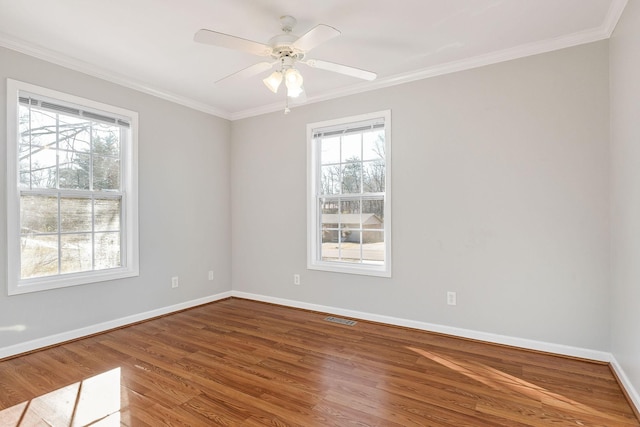 spare room with hardwood / wood-style flooring, ornamental molding, and ceiling fan