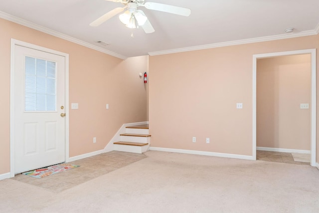 carpeted foyer entrance with crown molding and ceiling fan