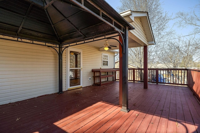 wooden deck featuring a gazebo and ceiling fan