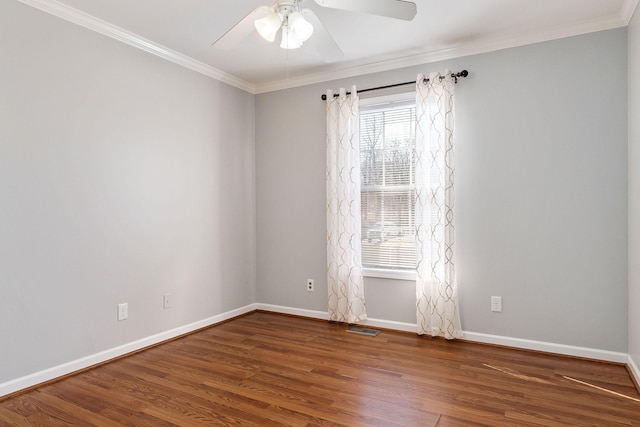 empty room with crown molding, dark hardwood / wood-style floors, and ceiling fan