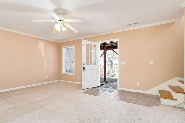 carpeted foyer entrance with ceiling fan and ornamental molding