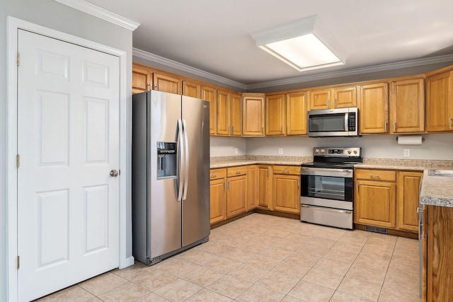 kitchen with stainless steel appliances, crown molding, and light tile patterned floors