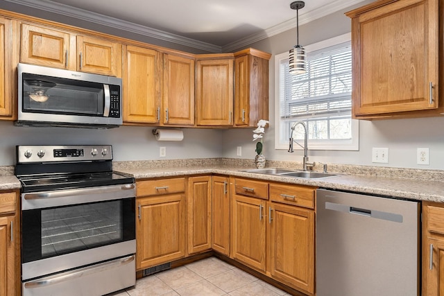 kitchen featuring appliances with stainless steel finishes, pendant lighting, sink, ornamental molding, and light tile patterned floors