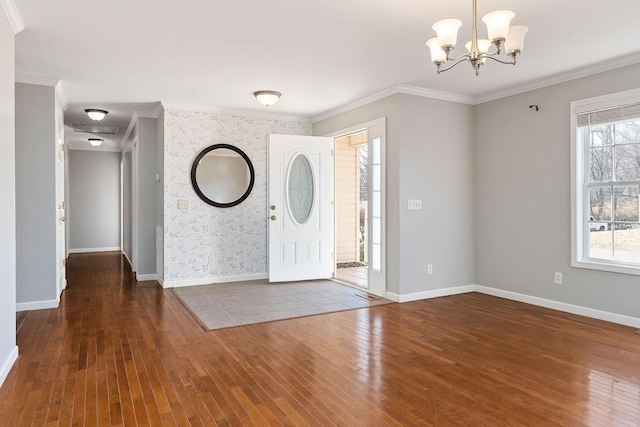 entrance foyer with a notable chandelier, crown molding, and wood-type flooring