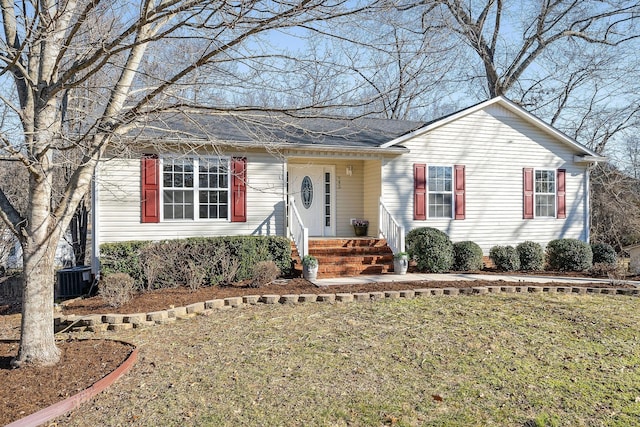 single story home with central AC and a front yard