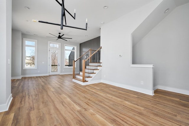 unfurnished living room with light hardwood / wood-style flooring and ceiling fan