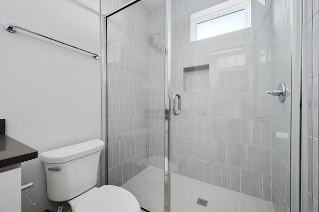 bathroom with vanity, an enclosed shower, and toilet