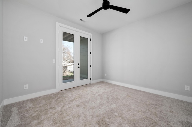 carpeted empty room featuring french doors and ceiling fan