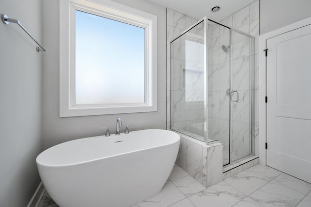 bathroom featuring shower with separate bathtub