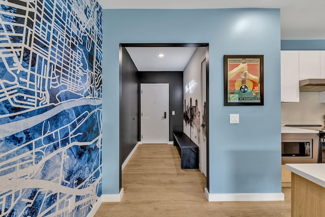 hall with light hardwood / wood-style flooring