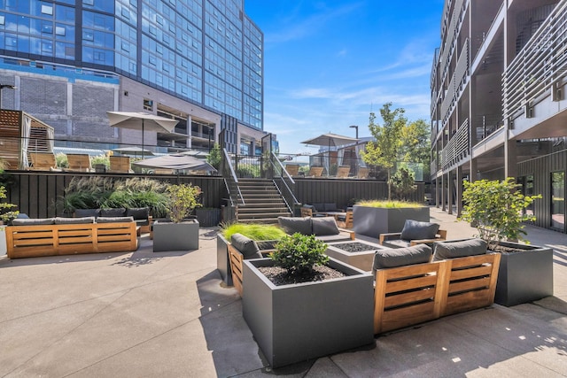 view of patio featuring an outdoor living space with a fire pit