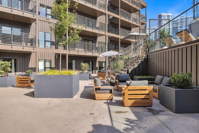 view of community with an outdoor living space and a patio area