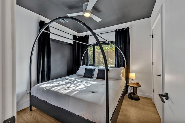 bedroom with ceiling fan and light hardwood / wood-style flooring