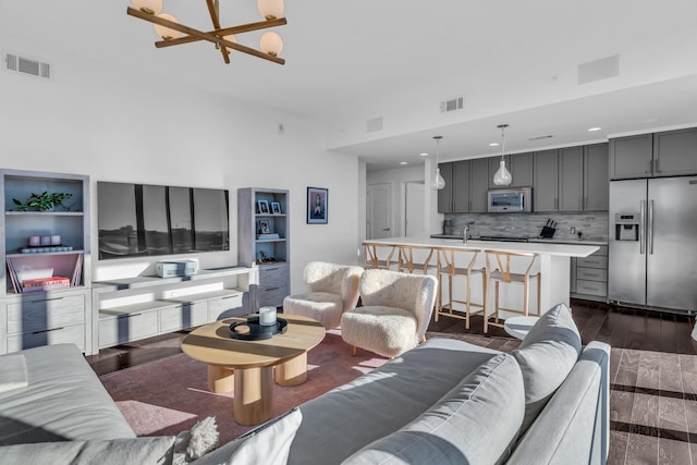 living room featuring dark wood-type flooring and a chandelier