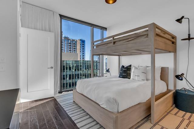 bedroom featuring floor to ceiling windows, access to exterior, and light wood-type flooring