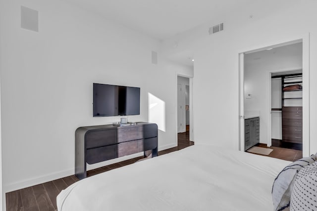 bedroom with dark hardwood / wood-style flooring