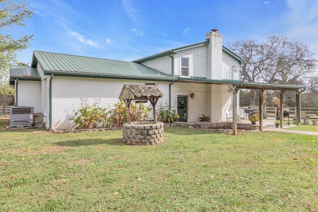 rear view of house featuring a patio area, a lawn, and central air condition unit