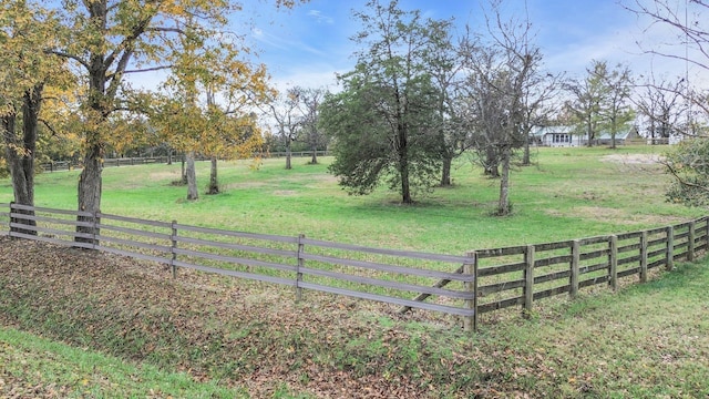 view of gate featuring a rural view and a yard