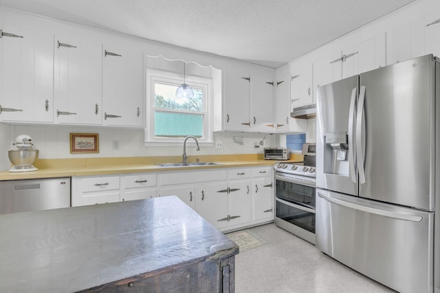 kitchen featuring white cabinetry, appliances with stainless steel finishes, sink, and a textured ceiling