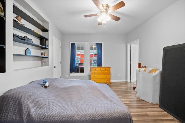 bedroom with ceiling fan and light wood-type flooring