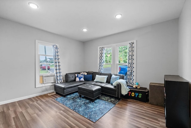 living room with cooling unit and hardwood / wood-style flooring