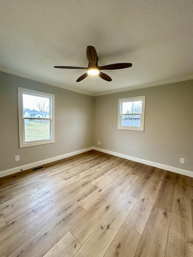 unfurnished room with ornamental molding, ceiling fan, a textured ceiling, and light hardwood / wood-style floors