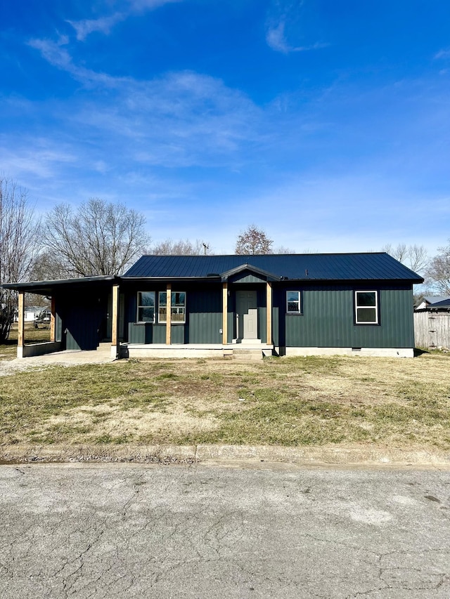 ranch-style house with a carport and a front lawn