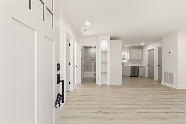 corridor with light wood-type flooring