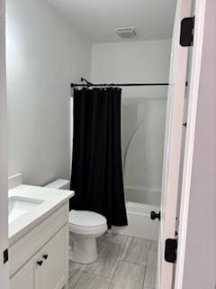 full bathroom with vanity, shower / bath combination with curtain, and toilet