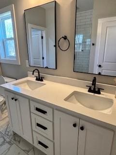 bathroom featuring vanity and toilet