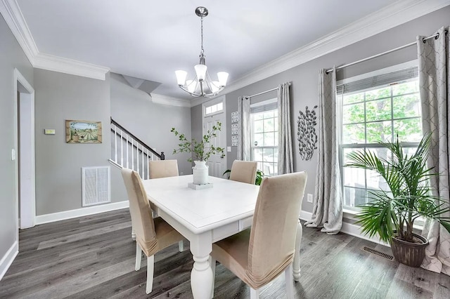 dining room with crown molding, dark hardwood / wood-style floors, and a notable chandelier