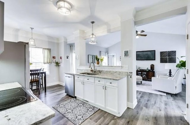 kitchen with white cabinetry, stainless steel appliances, sink, and pendant lighting