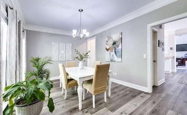 dining room featuring a notable chandelier, crown molding, and wood-type flooring