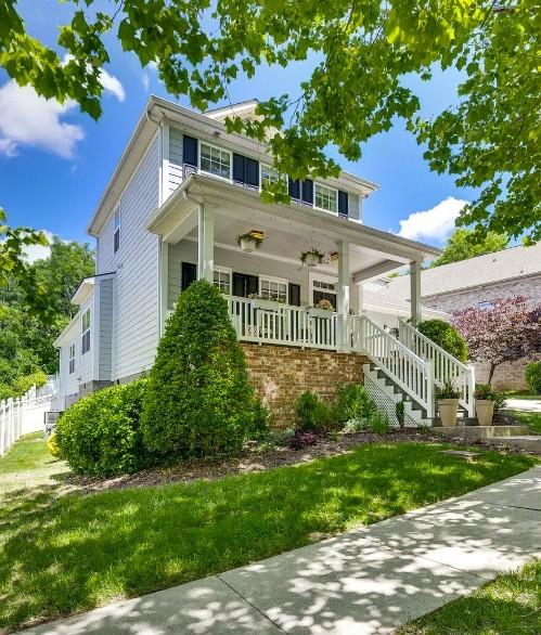 view of front of home with a front yard and covered porch