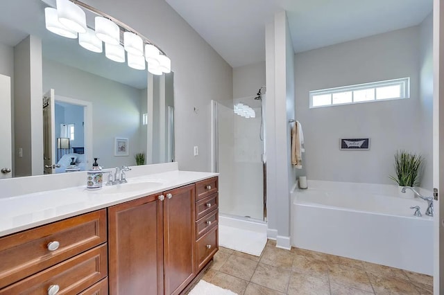 bathroom with tile patterned flooring, shower with separate bathtub, and vanity