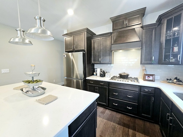 kitchen with dark hardwood / wood-style flooring, decorative light fixtures, tasteful backsplash, and appliances with stainless steel finishes