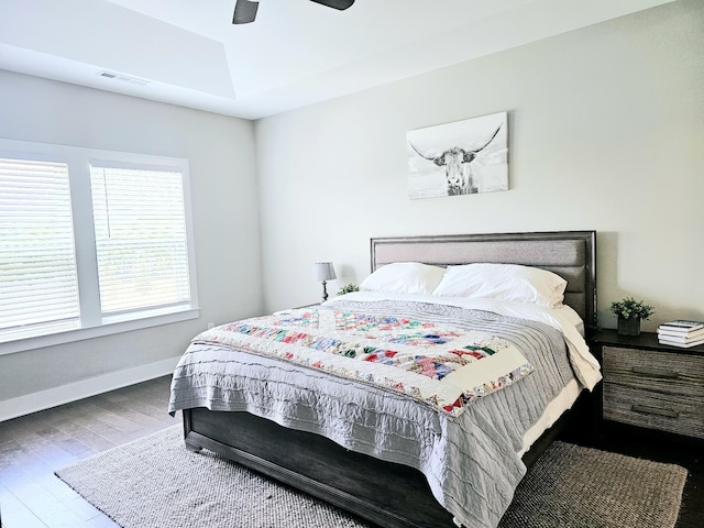 bedroom with wood-type flooring and ceiling fan