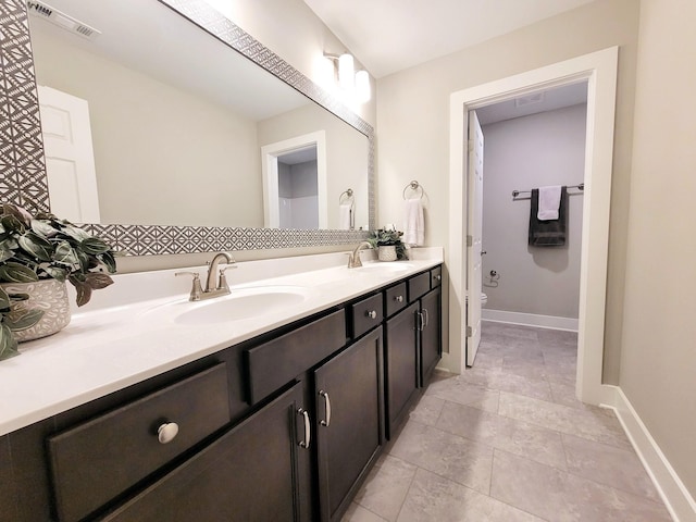 bathroom with vanity, tile patterned floors, and toilet