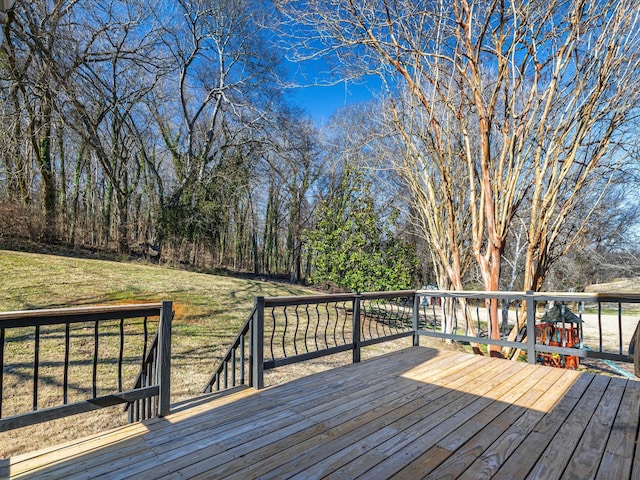 wooden terrace featuring a yard