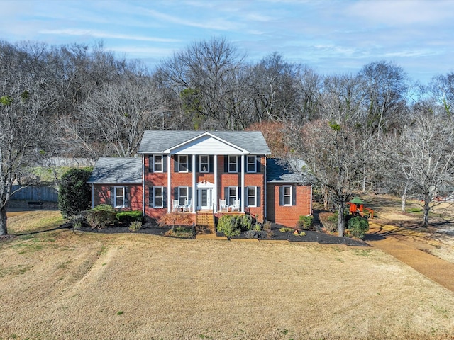 view of front of house with a front yard and covered porch