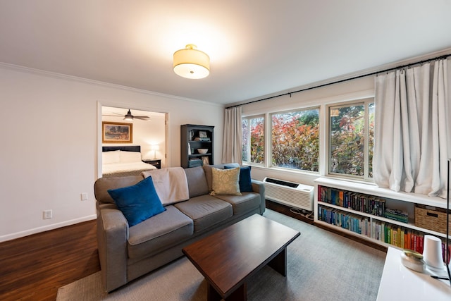 living room with crown molding, dark wood-type flooring, and a wall mounted AC