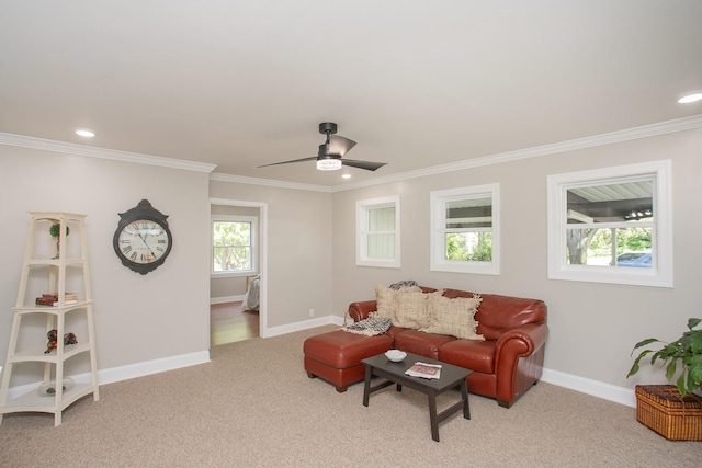 carpeted living room featuring crown molding and ceiling fan