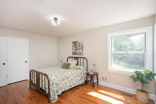 bedroom with hardwood / wood-style flooring