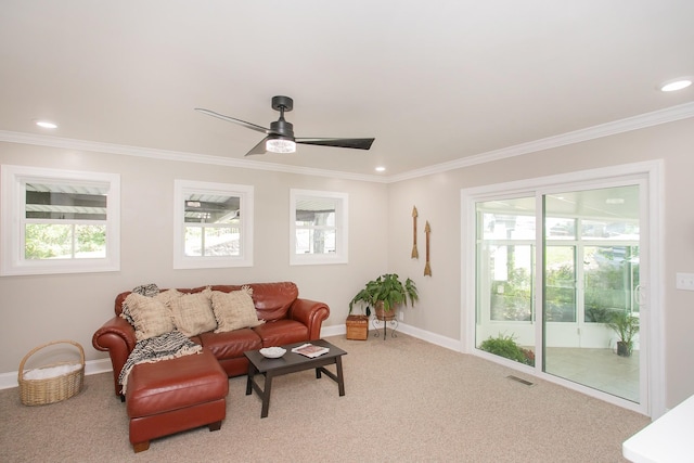 living room with crown molding, ceiling fan, and carpet