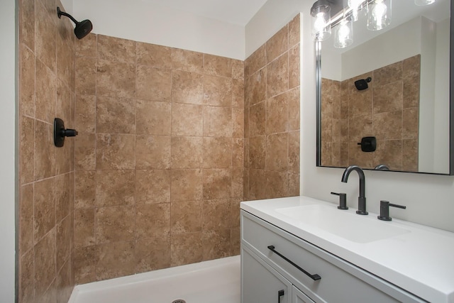 bathroom featuring vanity and tiled shower